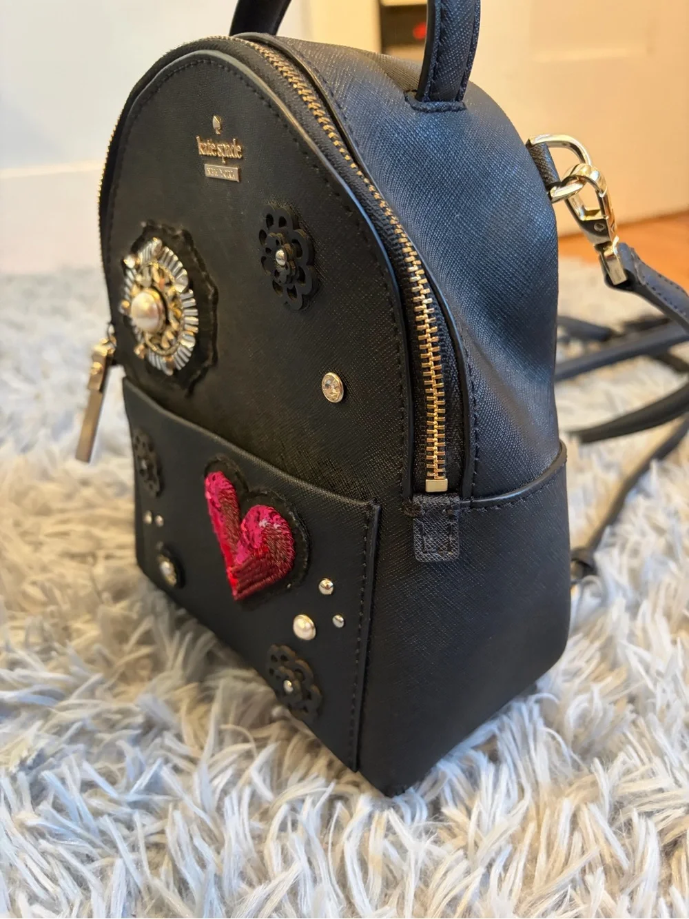 kate spade black mini backpack with red sequin heart and floral studs